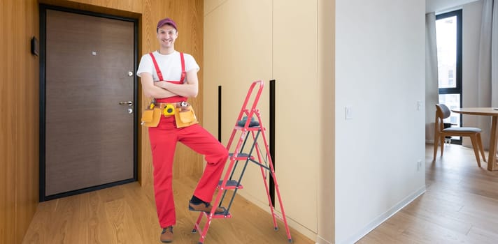 Builder handyman with construction tools. House renovation background.