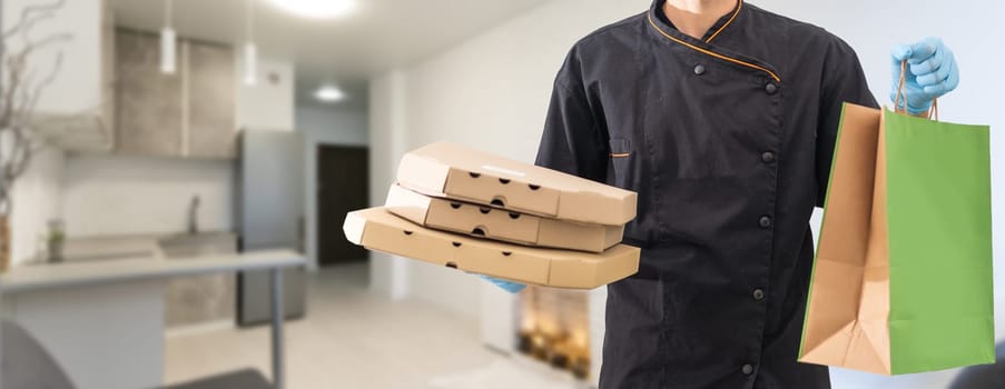 Young handsome delivery man holding paper bag with takeaway food happy with big smile