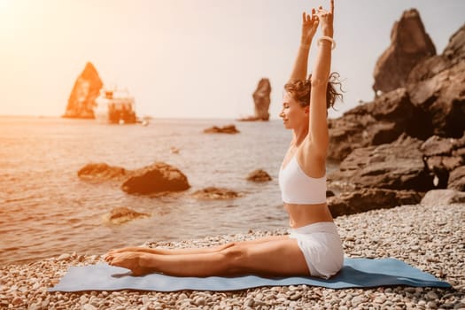 Woman sea yoga. Back view of free calm happy satisfied woman with long hair standing on top rock with yoga position against of sky by the sea. Healthy lifestyle outdoors in nature, fitness concept.