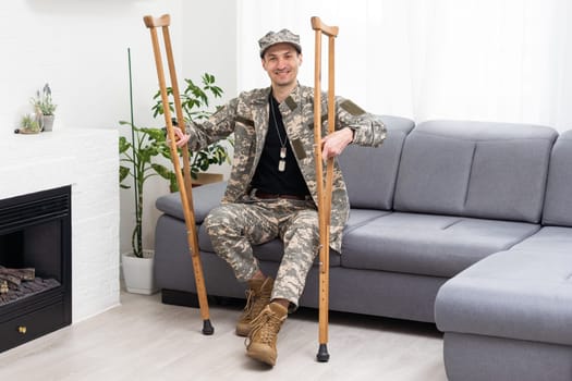 soldier in khaki military uniform on crutches.