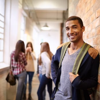 University, education and portrait of man on campus ready for study, knowledge and learning. Scholarship, happy and face of male student in hallway with friends for school, academy and college class.