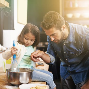 Learning, breakfast and father with daughter in kitchen for pancakes, bonding and cooking. Food, morning and helping with man and young girl in family home for baking, support and teaching nutrition.