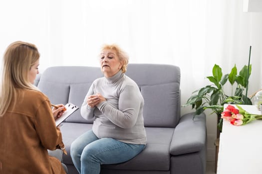 Excited grandmother talking to a psychologist about positive life of pensioner.