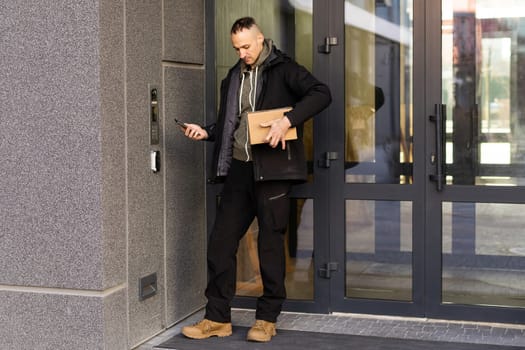 Man uses smartphone to open the door of his house