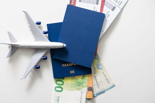 Airplane, passport and money - traveling concept.