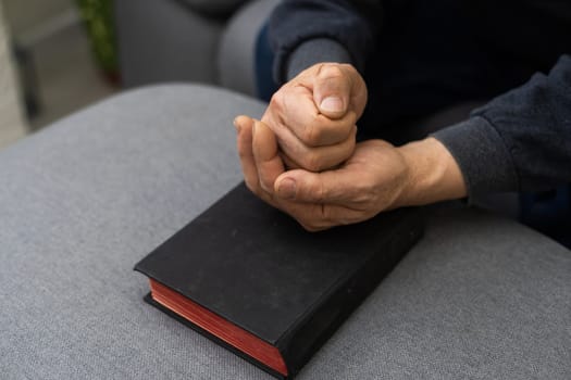 Hands of man praying to god with the bible, Concept of faith for god.