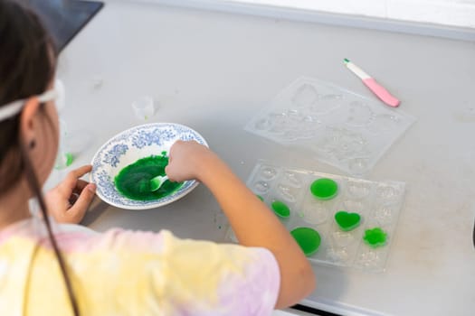 Children are learning and doing science experiments. Little girl playing science experiment for home schooling. Easy and fun science experiments for kids at home