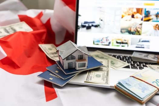 laptop with travel, money and canada flag.