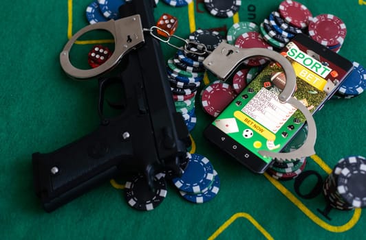 Casino chips a winning combination of cards flush royal next to the police handcuffs.