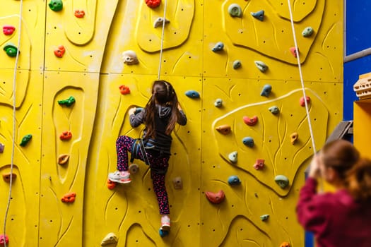 Little Girl Climbing Rock Wall.