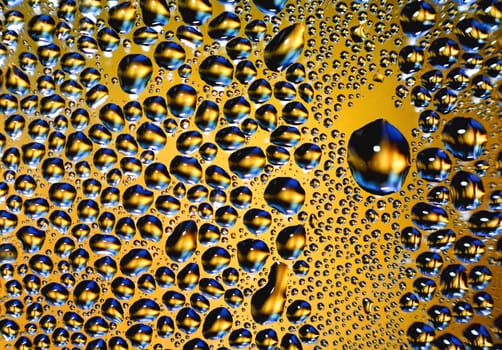 Abstract water drops on yellow background texture. backdrop glass covered with drops of water. bubbles in water. Background with Beautiful Big Drop