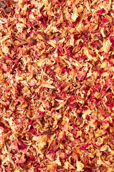 Texture dried rose petals, leaves. Potpourri, desiccated rose buds background. Top view aromatic herbal beverage made from fragrant flowers. Vertical from above, space for text. High quality photo