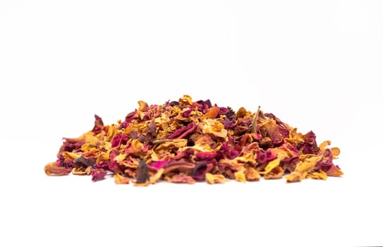 isolated handful of dried rose petals, leaves, buds on white background. Desiccated colorful flower petals for aromatic herbal tea, drink. Horizontal plane, close up, copy space. High quality photo