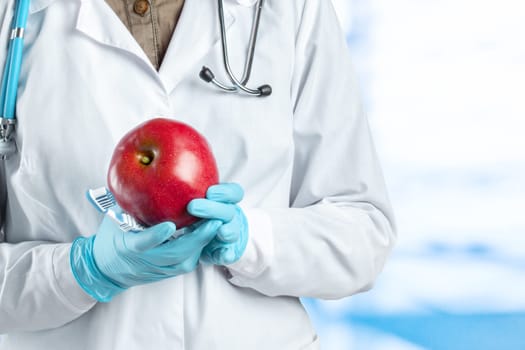 dentist holding a ripe apple