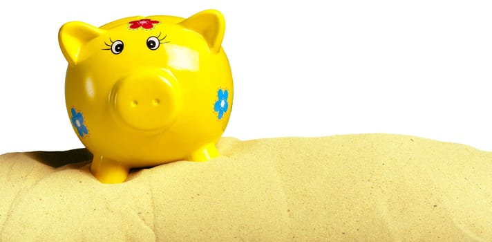 Summer piggy bank with sunglasses on the beach