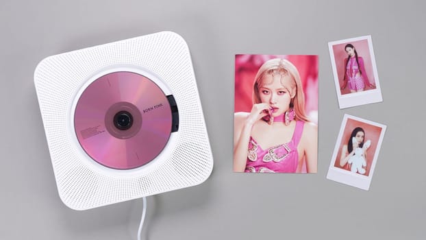 BlackPink BORN PINK 2nd Album collectible photo card with Rose on grey. Pink music CD in player. South Korean girl group BlackPink. Space for text. Gatineau, QC Canada - November 10 2022.