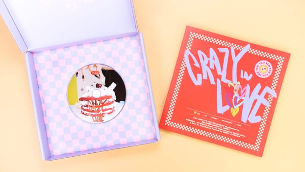 K-pop group Itzy CRAZY IN LOVE 1st Album on yellow background. Special edition music CD. South Korean girl group Itzy. Space for text. Gatineau, QC Canada - March 10 2023.