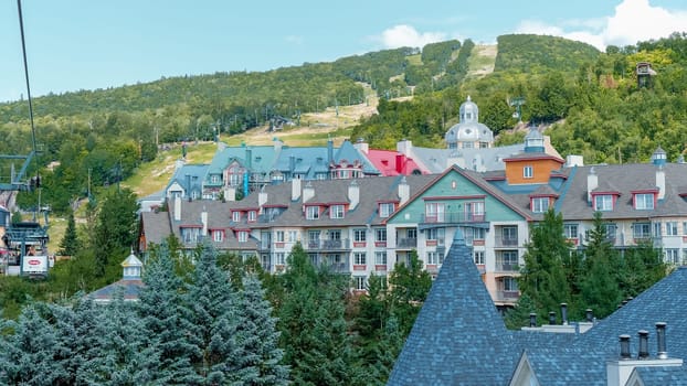 Sightseeing views by cable car at Mont Tremblant ski Resort in summer. Ski resort village view from open funicular cabin. Mont-Tremblant, Quebec, Canada - 22.09.2022.