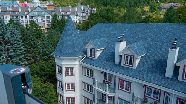 Sightseeing views by cable car at Mont Tremblant ski Resort in summer. Ski resort village view from open funicular cabin. Mont-Tremblant, Quebec, Canada - 22.09.2022.