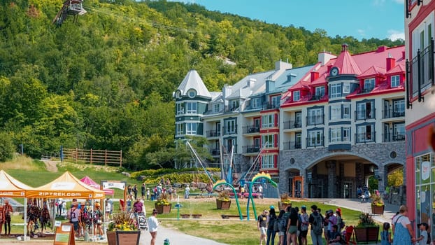 Sightseeing views colorful hotels at Mont Tremblant ski Resort in summer. Ski resort village view from open funicular cabin. Mont-Tremblant, Quebec, Canada - 22.09.2022.