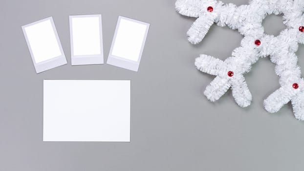 Retro photo frames isolated on grey background. Real photo template. Three frames. Mockup. Christmas white fluffy snowflake. Winter decoration