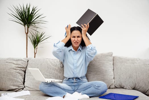 Female student in stress cannot solve the problem. Girl with horror holds her head and tries to find a solution to the tasks