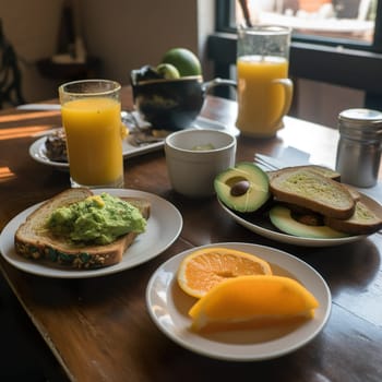 Tasty breakfast with avocado tiast and orange juice . High quality photo
