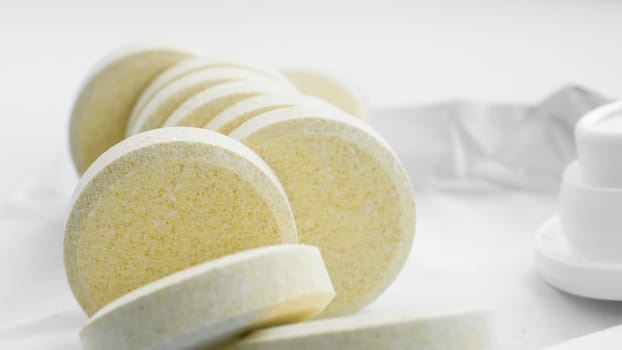 Vitamins and nutritional supplements. Heap of soluble effervescent vitamin tablets on a white background. Health care and medical. Front view.