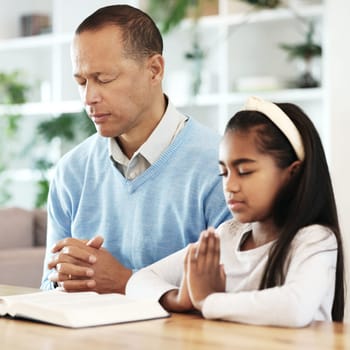 Bible books, family and child in prayer for support, faith and christian worship at home. Father, girl kid and praying of religion, spiritual trust or reading holy gospel of god, jesus christ or hope.