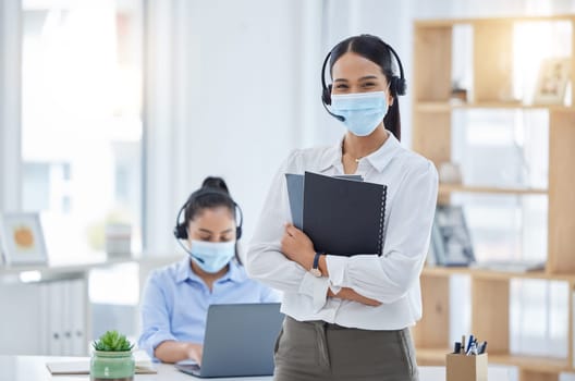 Covid, receptionist in a mask at office and professional business secretary working through pandemic. Corporate woman employees, during coronavirus epidemic and focus on health or safety at workplace.