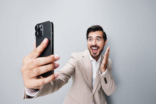 confident man trading corporate blogger message online hold application app suit cellphone smile smartphone beard happy business portrait phone call person