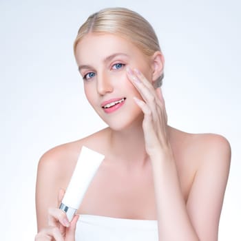 Closeup personable beautiful perfect natural skin woman hold mockup tube moisturizer cream for skincare treatment product advertising expressive facial and gesture expression in isolated background.