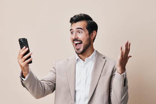 man happy businessman success cellphone phone gray call young trading hold smartphone mobile connection internet suit lifestyle smile cell business portrait