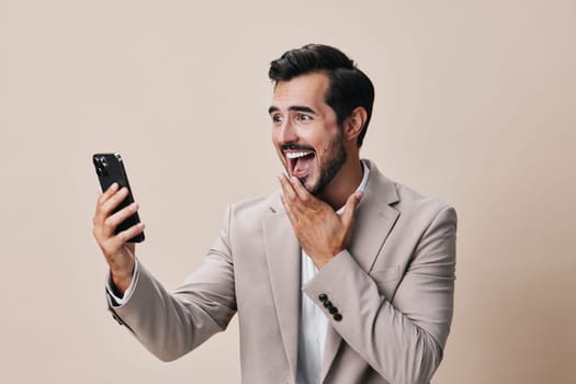phone man call beige portrait entrepreneur young happy handsome lifestyle smartphone internet cyberspace guy application business hold suit smile app communication