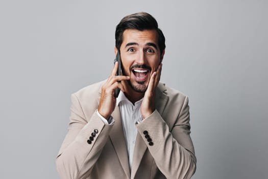 man suit space cell hold isolated person call smile copy phone entrepreneur portrait handsome happy beard white smartphone lifestyle trading business businessman