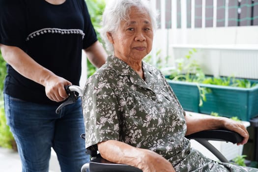 Doctor help Asian elderly woman disability patient sitting on wheelchair in hospital, medical concept.