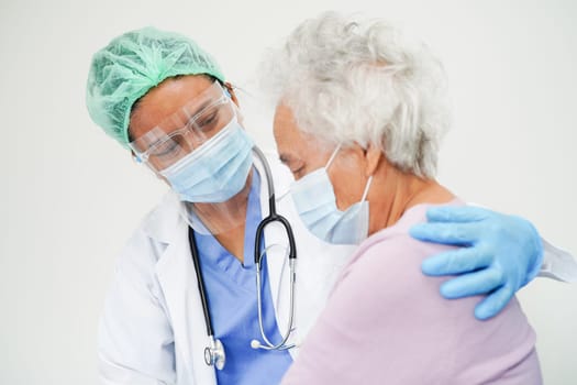 Doctor check Asian elder senior woman patient wearing a mask for protect covid coronavirus.