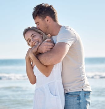 Beach holiday, travel and couple hug, happy smile and enjoy summer together, romance and anniversary in summer. Man and woman with care, embracing and bonding in nature by the ocean on vacation.