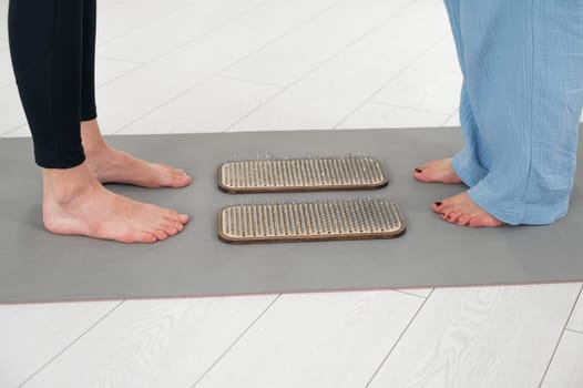 Female feet next to sadhu boards in yoga studio