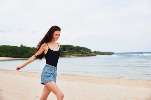 lifestyle woman space travel sea person sunset walking long positive carefree beach sand smile summer running wave beauty copy young hair fun leisure