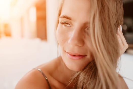 Happy woman portrait in cafe. Boho chic fashion style. Outdoor photo of young happy woman with long hair, sunny weather outdoors sitting in modern cafe