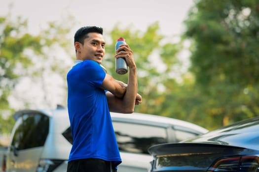 Sporty man resting after workout session and stretching arms. Fitness, sport and healthy lifestyle concept.