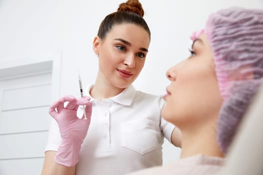 Cosmetologist performs the lift procedure by injecting beauty injections. Doctor injecting hyaluronic acid as a facial rejuvenation treatment