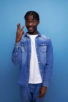 smart african man with dreadlocks on blue background.