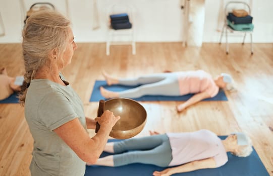Sound bowl, women healing and healer with senior class for music therapy meditation, alternative medicine or audio holistic healthcare. Yoga, chakra and reiki energy support for relax people on floor.