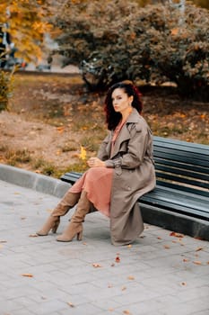 A woman walks outdoors in autumn, enjoys the autumn weather