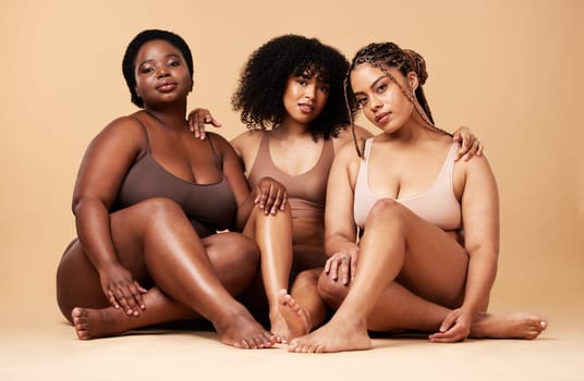 Diversity women, skin and beauty portrait with friends group together for inclusion and power. Natural body model people on beige background with glow, pride and self love motivation in underwear.