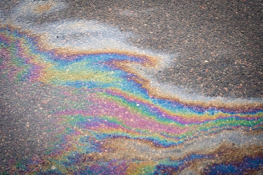 Gasoline stains on asphalt. Gasoline spilled on road.