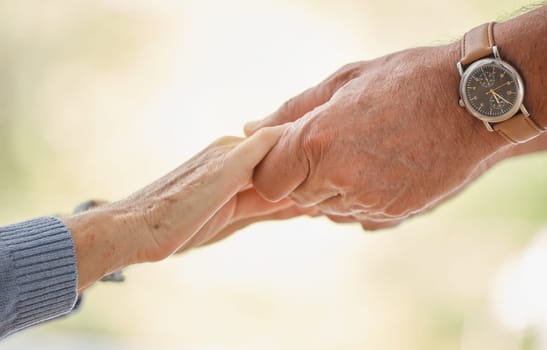 Holding hands, support and trust with senior couple, love and solidarity with helping hands and partnership outdoor. Help, commitment and faith, elderly people with hand holding, together and love