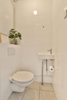 a bathroom with white tiles and a plant on the toilet tank in the corner, next to it is an open shower stall